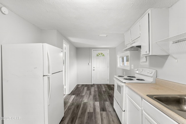 1905 W 17th St, Panama City, FL 32405 - kitchen with dark wood-type flooring, light countertops, white appliances, and white cabinets