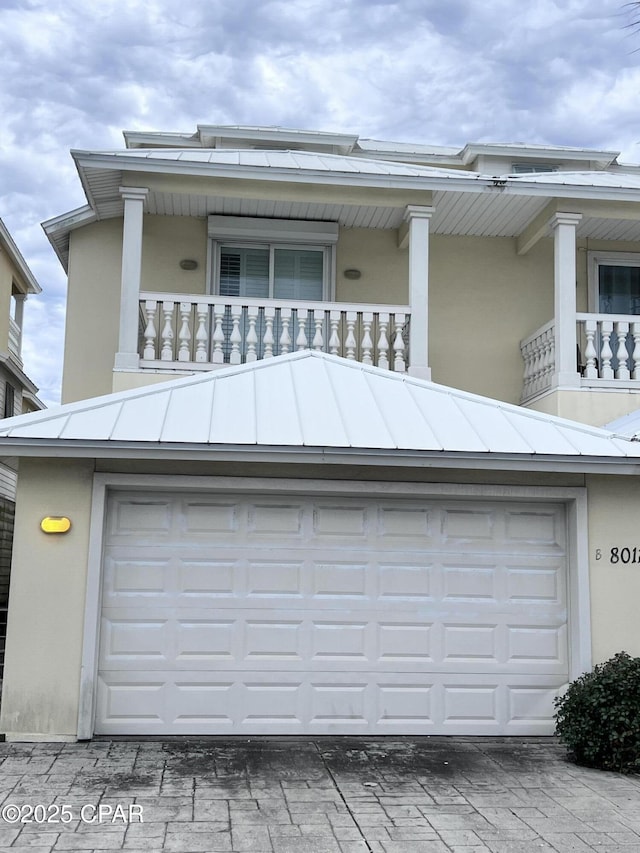 view of front of house with a balcony and a garage