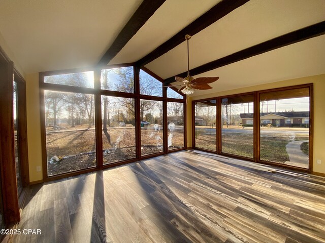 unfurnished sunroom featuring vaulted ceiling with beams