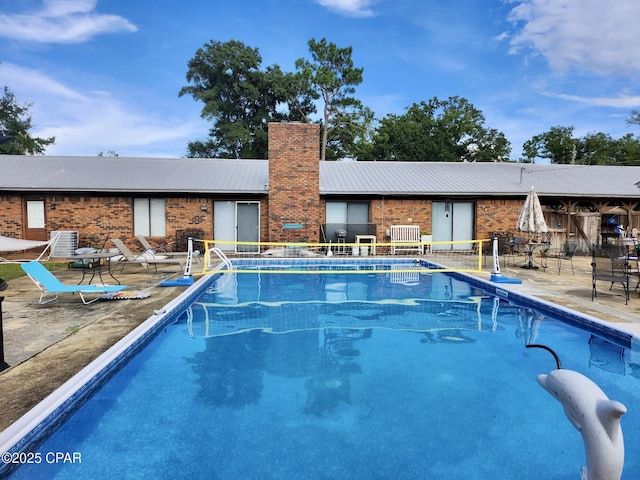 view of swimming pool with a patio area