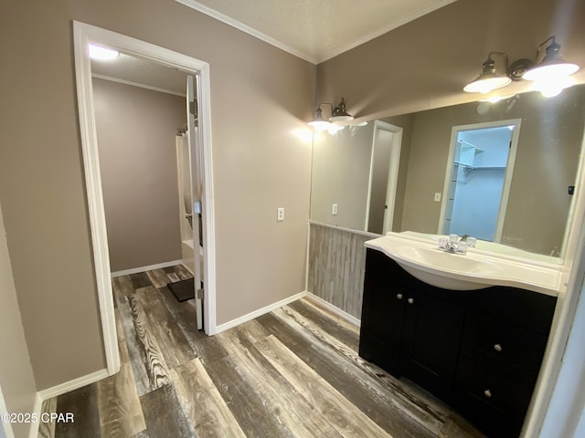 bathroom with ornamental molding, vanity, shower / bathtub combination with curtain, and hardwood / wood-style floors