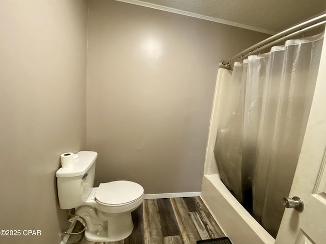 bathroom with hardwood / wood-style floors, shower / tub combo, and toilet