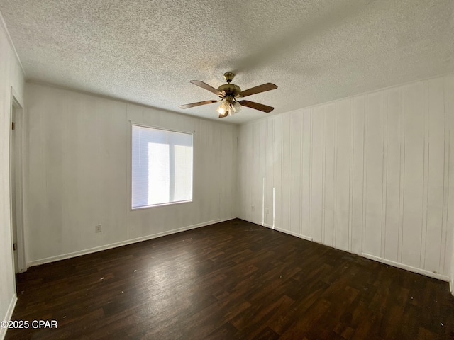 unfurnished room with ceiling fan, dark hardwood / wood-style flooring, and a textured ceiling