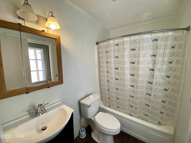 full bathroom featuring shower / tub combo with curtain, toilet, crown molding, a textured ceiling, and vanity