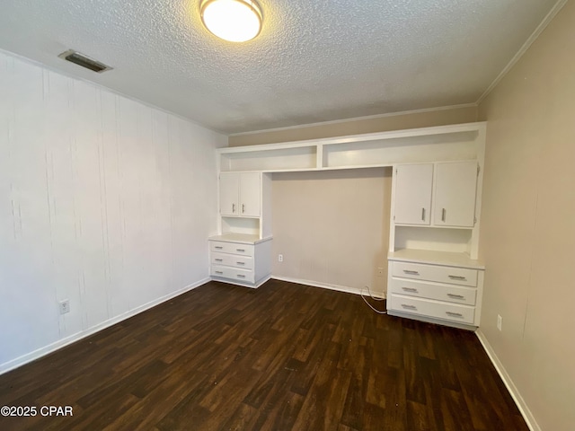 unfurnished bedroom featuring dark hardwood / wood-style floors and a textured ceiling