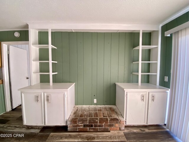 mudroom with dark wood-type flooring and a textured ceiling