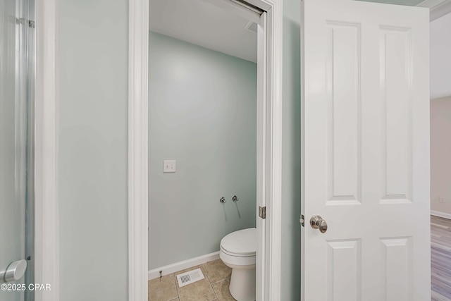 bathroom featuring tile patterned floors and toilet