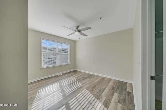 spare room with ceiling fan and light hardwood / wood-style flooring