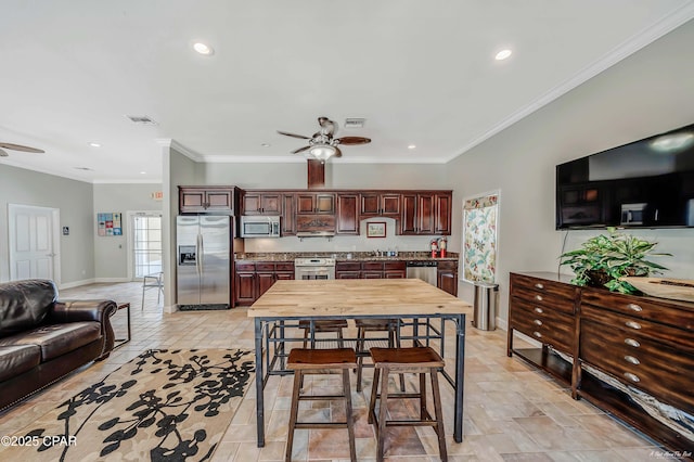 dining room with ornamental molding and ceiling fan