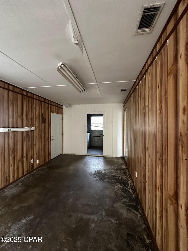 interior space featuring wooden walls and visible vents