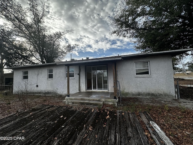 back of house with stucco siding