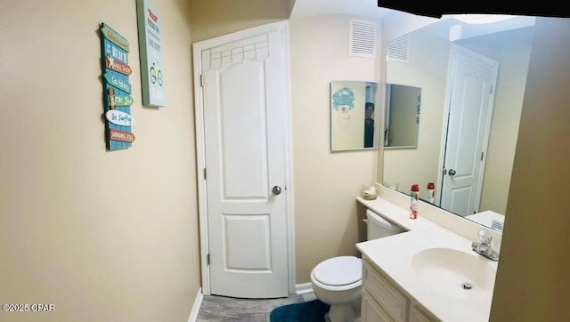 bathroom with vanity and toilet