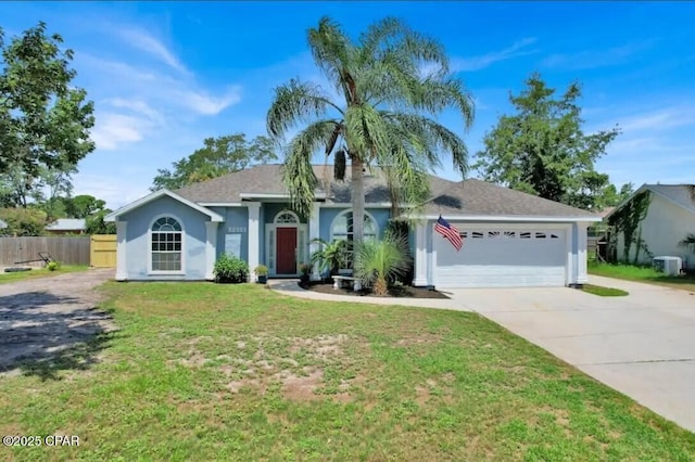 single story home featuring a garage and a front lawn