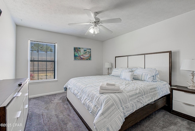 bedroom with ceiling fan, a textured ceiling, baseboards, and dark colored carpet