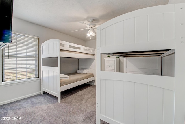 unfurnished bedroom with a ceiling fan, carpet, and baseboards