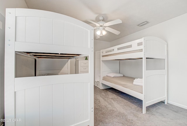 unfurnished bedroom with carpet flooring, baseboards, visible vents, and ceiling fan