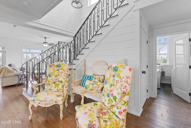 stairs with crown molding, ceiling fan, and hardwood / wood-style floors