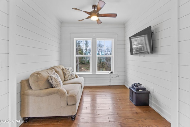 sitting room featuring dark hardwood / wood-style floors and ceiling fan