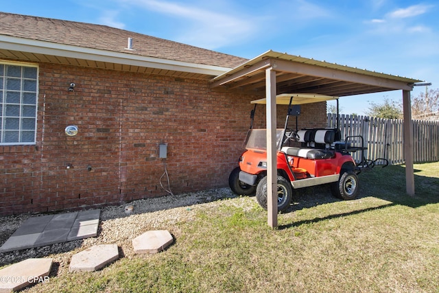 view of parking featuring a carport and a lawn