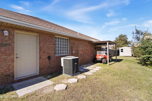 view of yard featuring a storage shed and central air condition unit