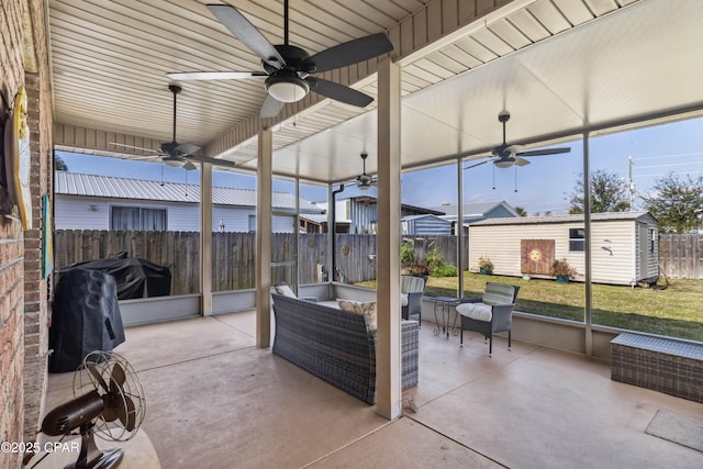 view of patio / terrace featuring ceiling fan, outdoor lounge area, and a shed