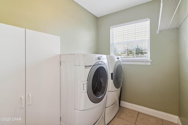 clothes washing area featuring light tile patterned floors and independent washer and dryer