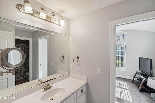 bathroom featuring vanity, toilet, and a textured ceiling