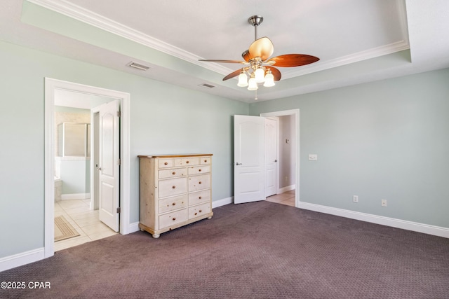 unfurnished bedroom featuring ceiling fan, connected bathroom, ornamental molding, light carpet, and a raised ceiling