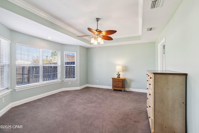 carpeted empty room featuring ceiling fan, ornamental molding, and a raised ceiling