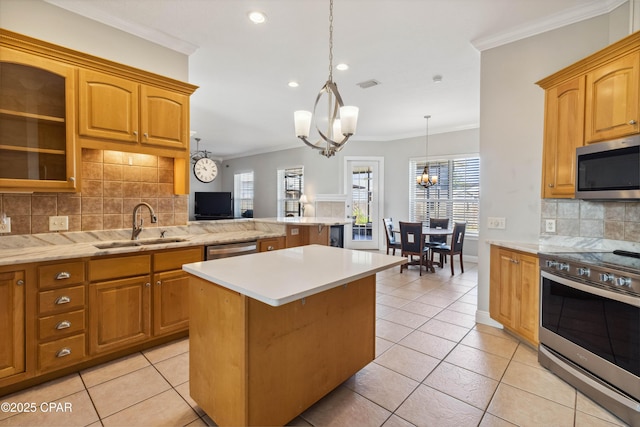 kitchen featuring a kitchen island, pendant lighting, decorative backsplash, a notable chandelier, and stainless steel appliances