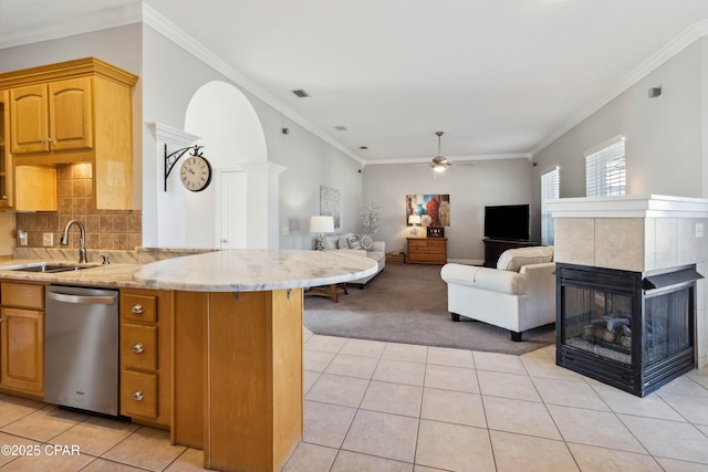 kitchen featuring sink, ornamental molding, stainless steel dishwasher, kitchen peninsula, and light carpet