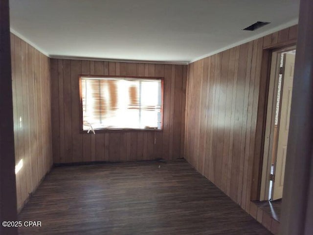 empty room featuring dark hardwood / wood-style floors and wood walls