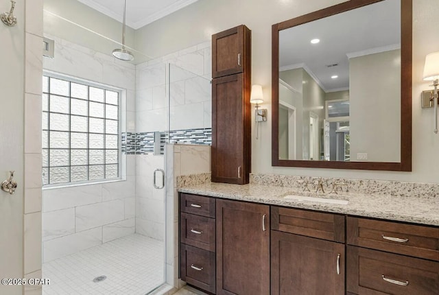 bathroom featuring walk in shower, ornamental molding, and vanity