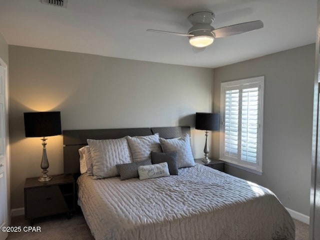 bedroom with ceiling fan and dark colored carpet