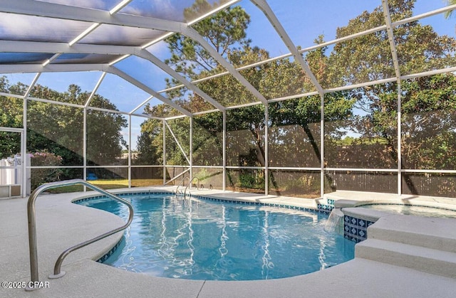 view of swimming pool with a patio, a jacuzzi, pool water feature, and glass enclosure