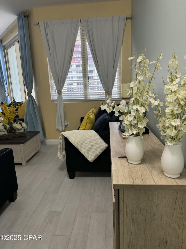 sitting room featuring light wood finished floors and baseboards