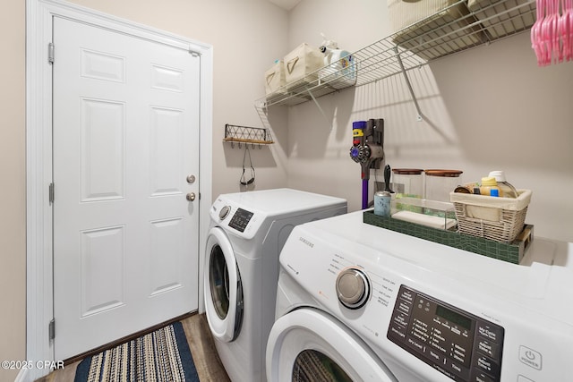 laundry room featuring hardwood / wood-style flooring and washer and clothes dryer