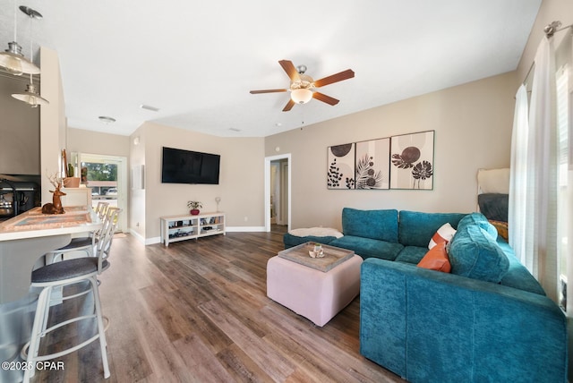 living room with hardwood / wood-style flooring and ceiling fan