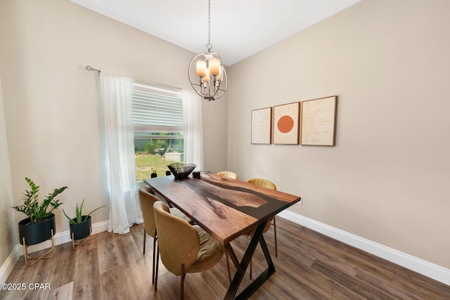 dining area with an inviting chandelier and dark hardwood / wood-style flooring