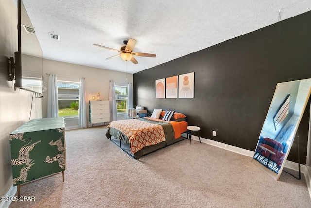 carpeted bedroom with a textured ceiling and ceiling fan