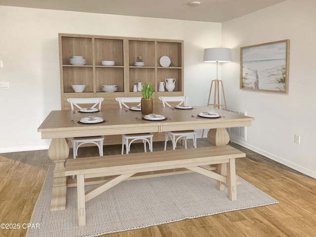 dining space with hardwood / wood-style flooring