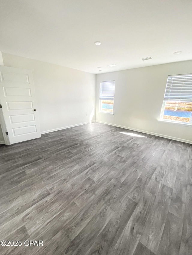 empty room with dark wood-type flooring