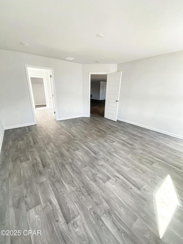 empty room with hardwood / wood-style floors