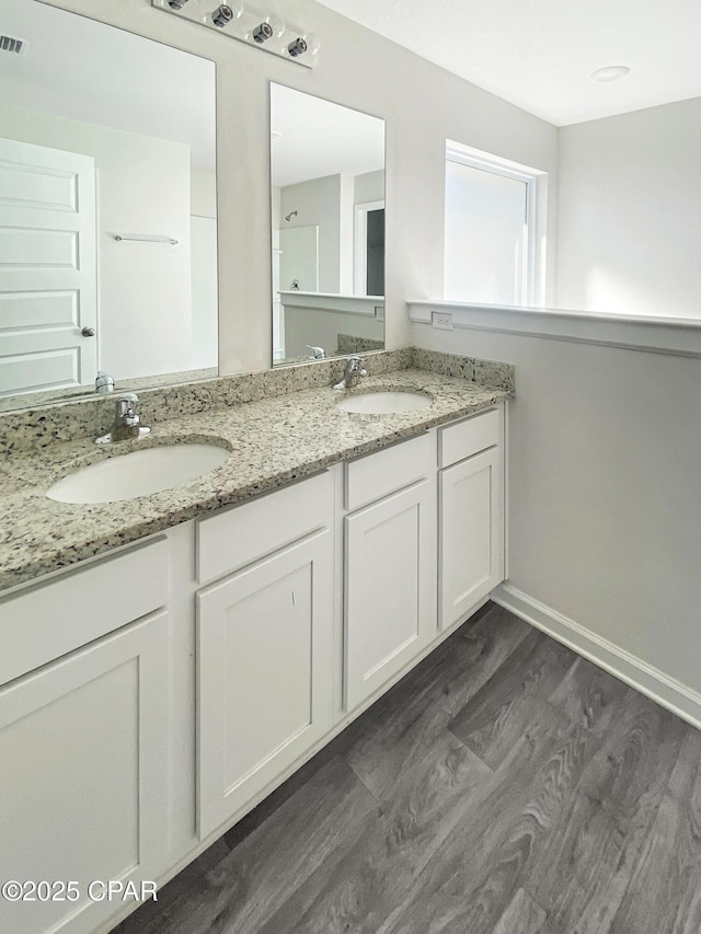 bathroom with vanity and wood-type flooring