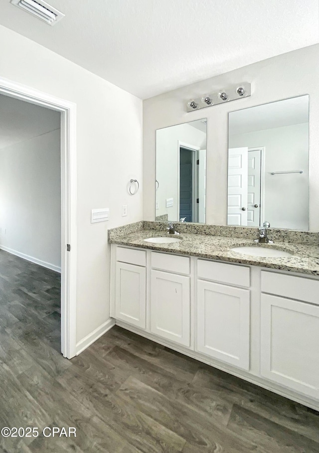 bathroom featuring vanity and wood-type flooring