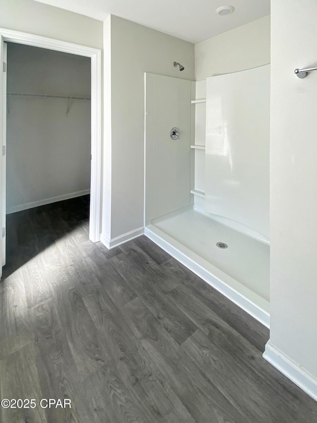 bathroom featuring wood-type flooring and a shower