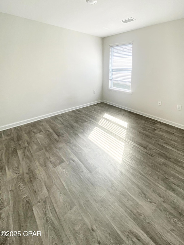 spare room with dark hardwood / wood-style floors