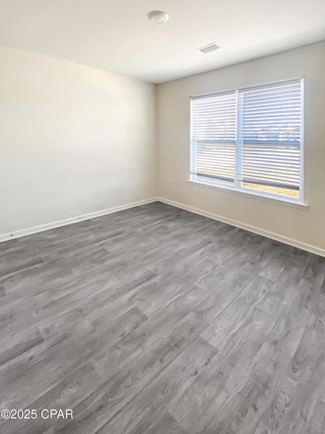 unfurnished room with dark wood-type flooring