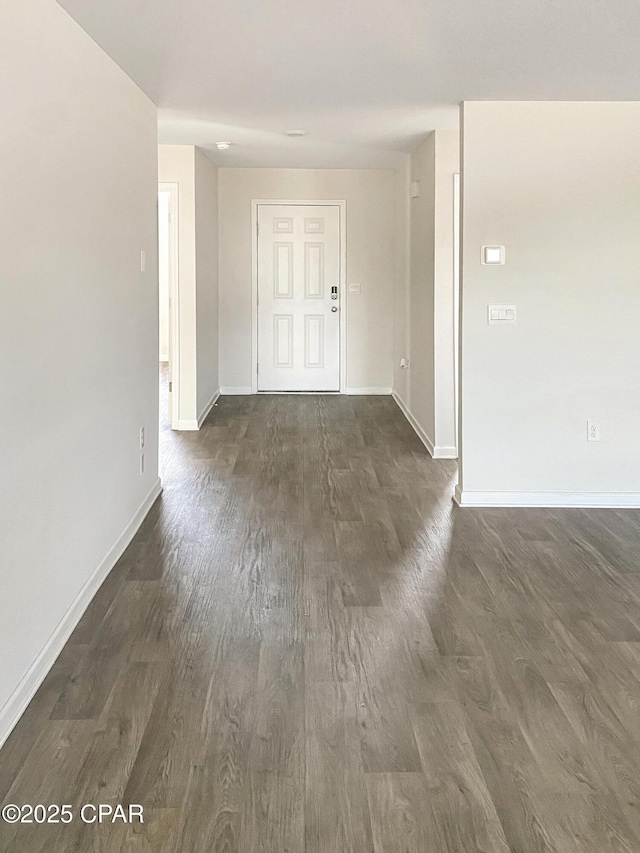 unfurnished room with dark wood-type flooring