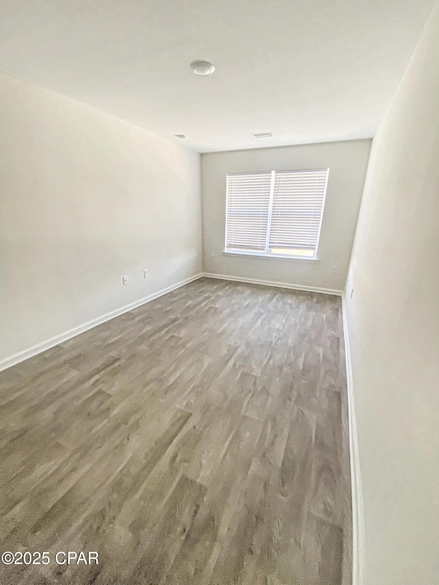 spare room featuring dark hardwood / wood-style floors